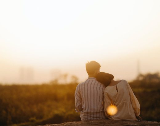 man and woman near grass field