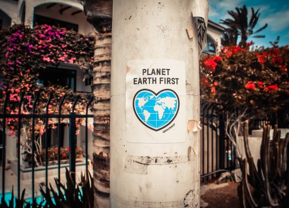 planet earth first poster on a concrete post