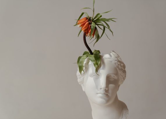 white ceramic woman with red flower