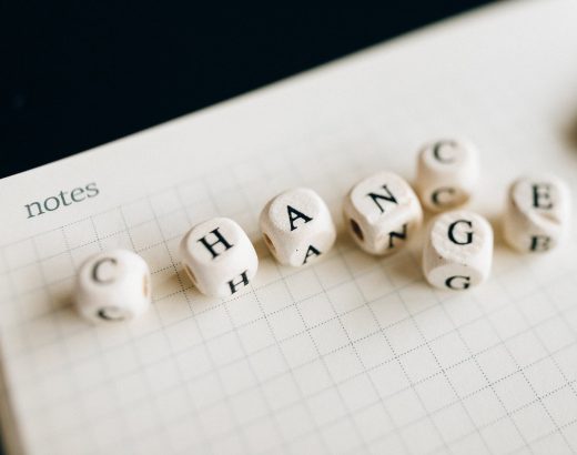 a close up shot of letter dice on an open notebook