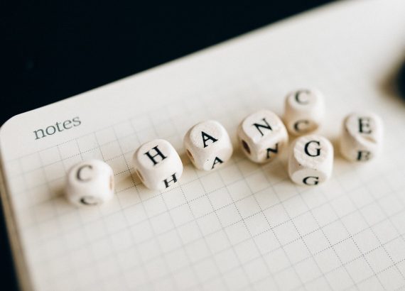 a close up shot of letter dice on an open notebook