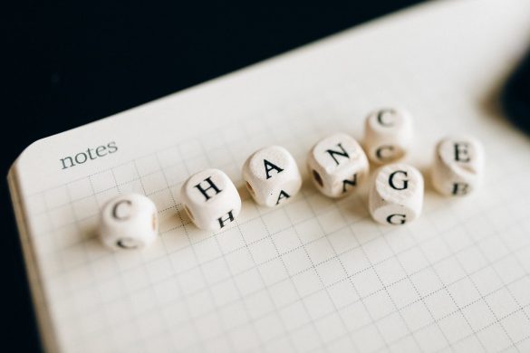 a close up shot of letter dice on an open notebook